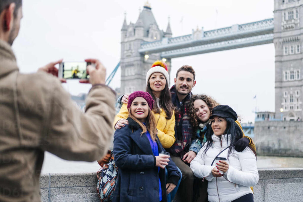 Destinations london united kingdom a group of friends take pictures with a mobile phone in front of tower bridge DGOF00497